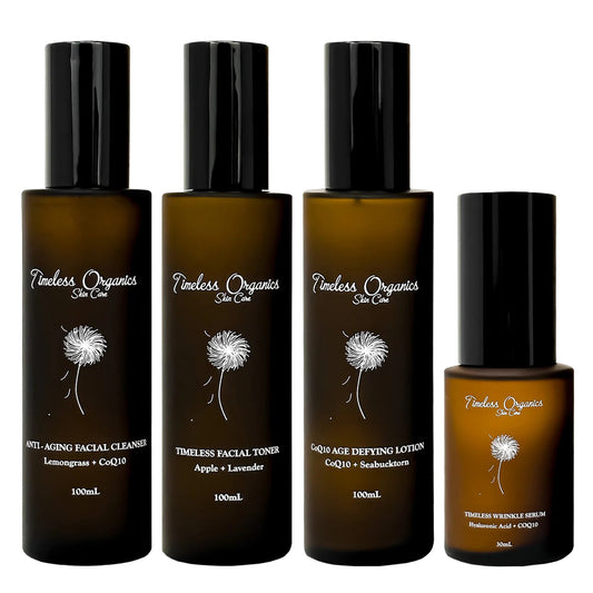 Four bottles of Timeless Organics skincare products on a white background