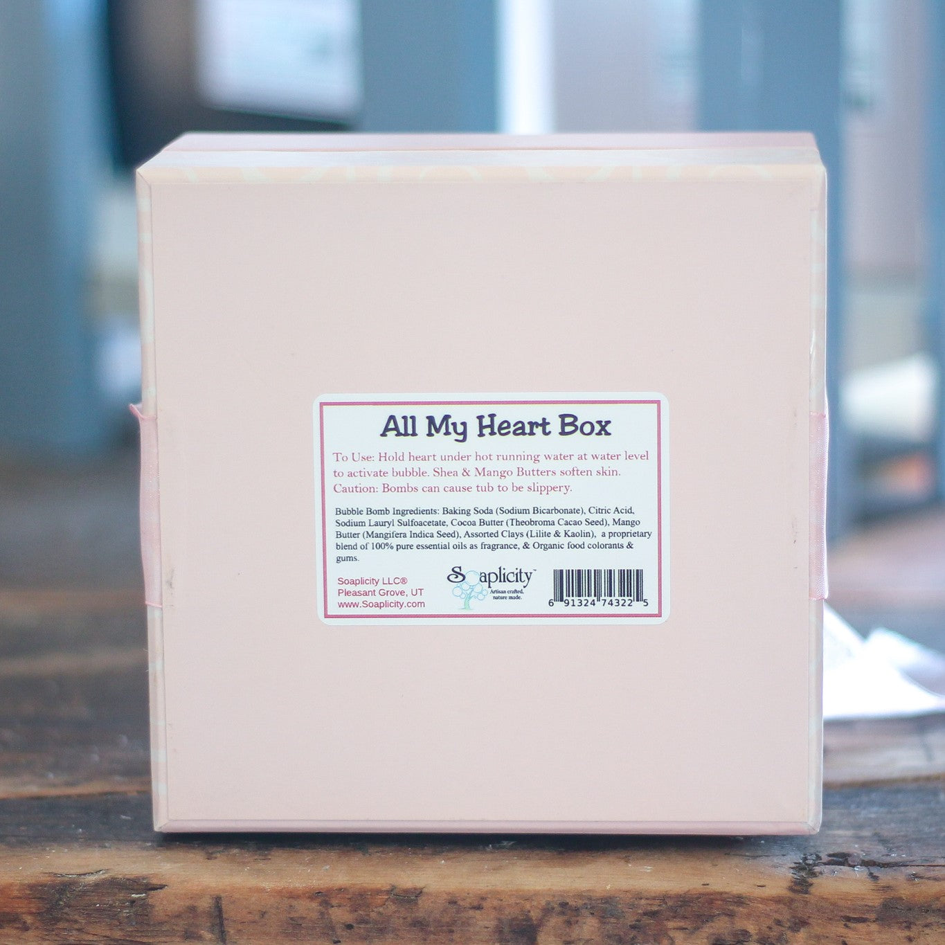 Box labeled 'All My Heart Box' on a wooden surface with a blurred background