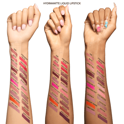 Three hands with Hydramatte Liquid Lipstick swatches on a white background