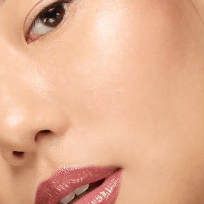 Close-up of a person's lips with a soft focus on the skin texture.