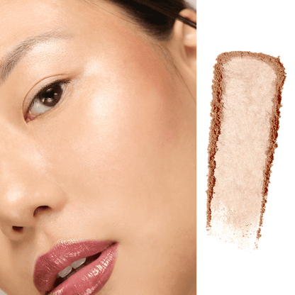 Close-up of a person's face with a swatch of makeup color on a white background