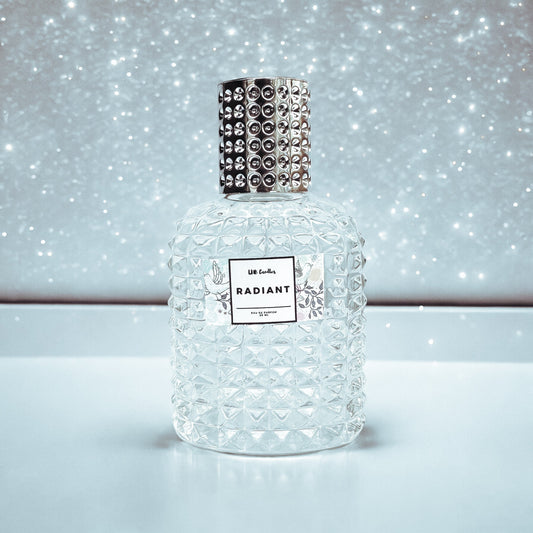 Perfume bottle labeled 'Radiant' with decorative cap on a sparkling background