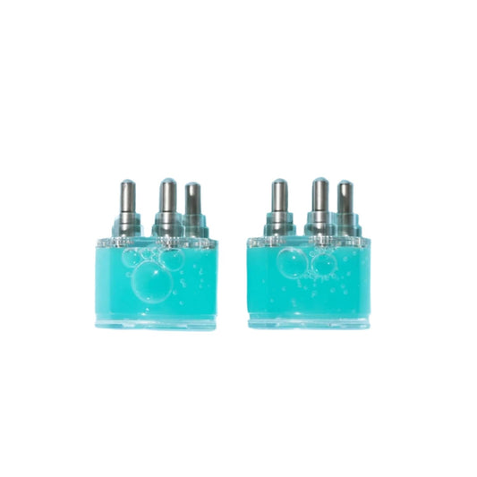 Two turquoise bottles with silver caps on a light  background